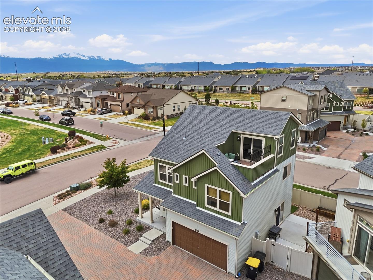 Multi-story residence featuring a two-tone facade, composition shingle roofing, and an integrated garage
