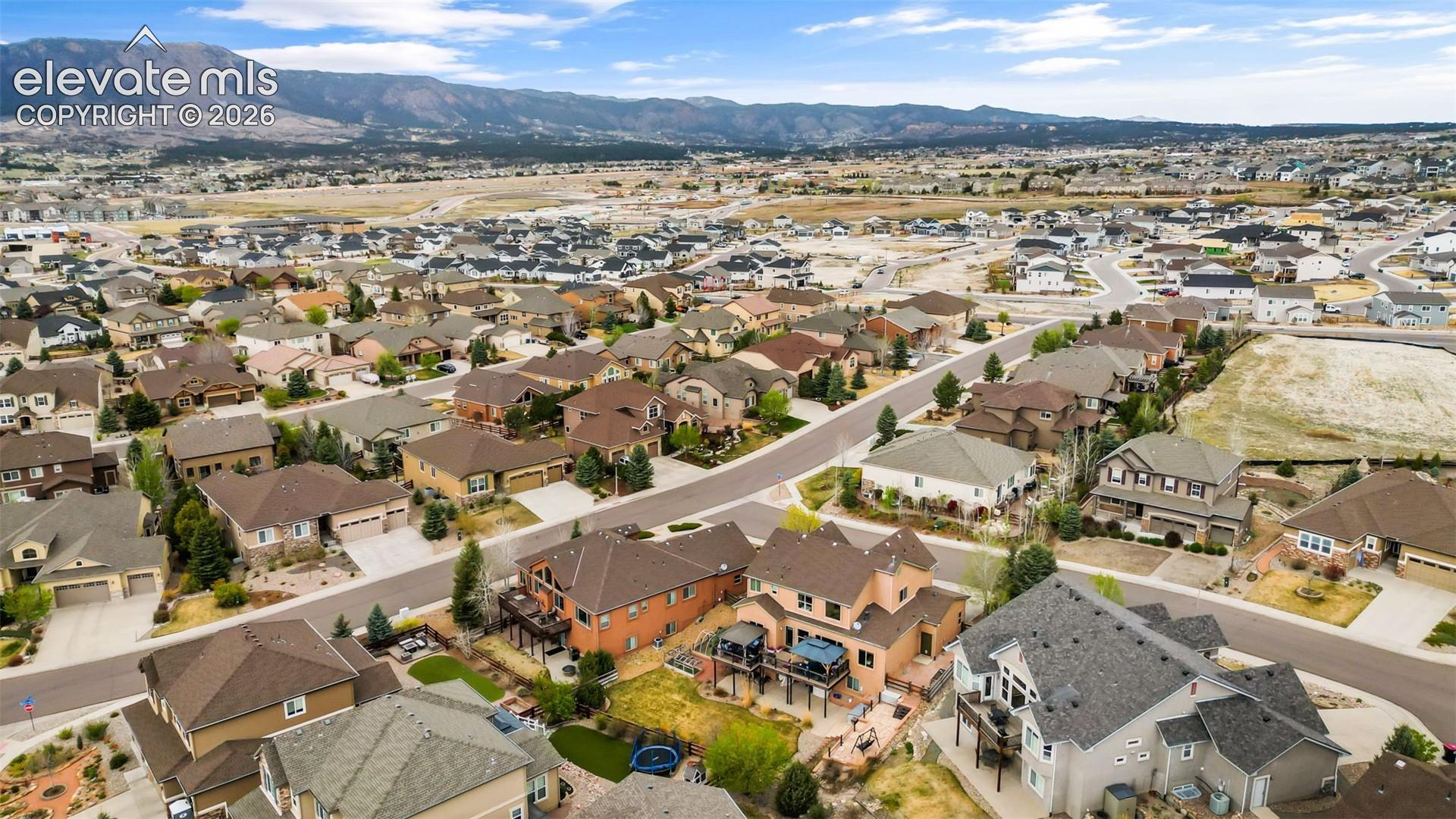 Expansive residential neighborhood featuring diverse architectural styles, paved streets, and mature landscaping