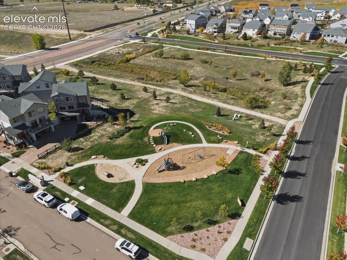 Community green space featuring a playground, walking paths, and landscaped areas