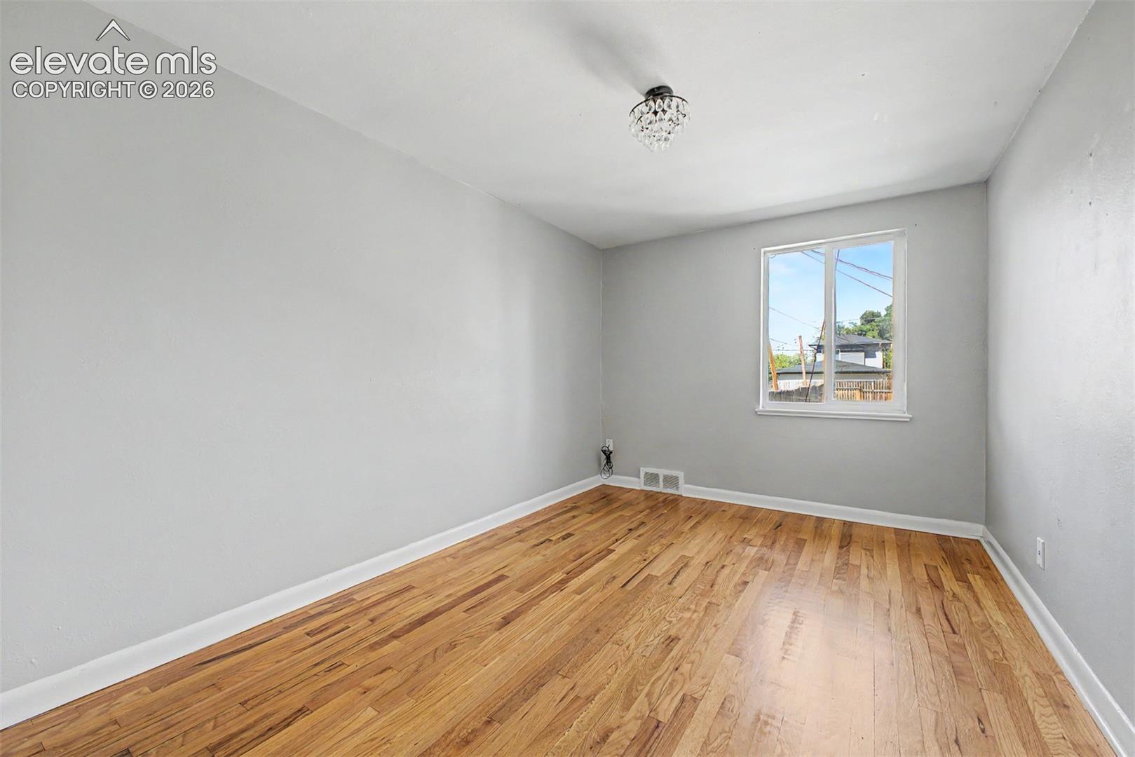 Hardwood flooring throughout, complemented by light gray walls