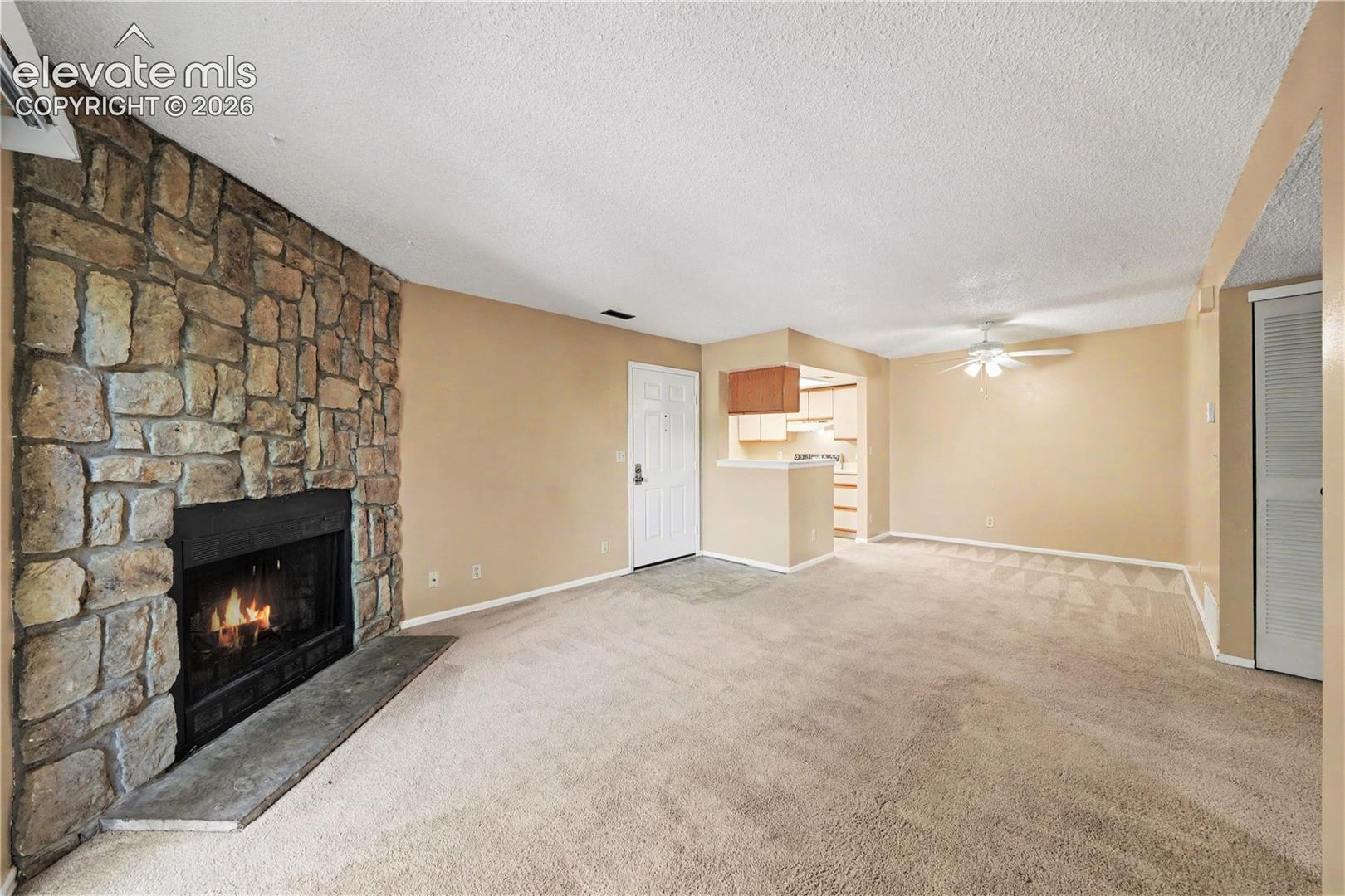 Open living and dining area with fireplace