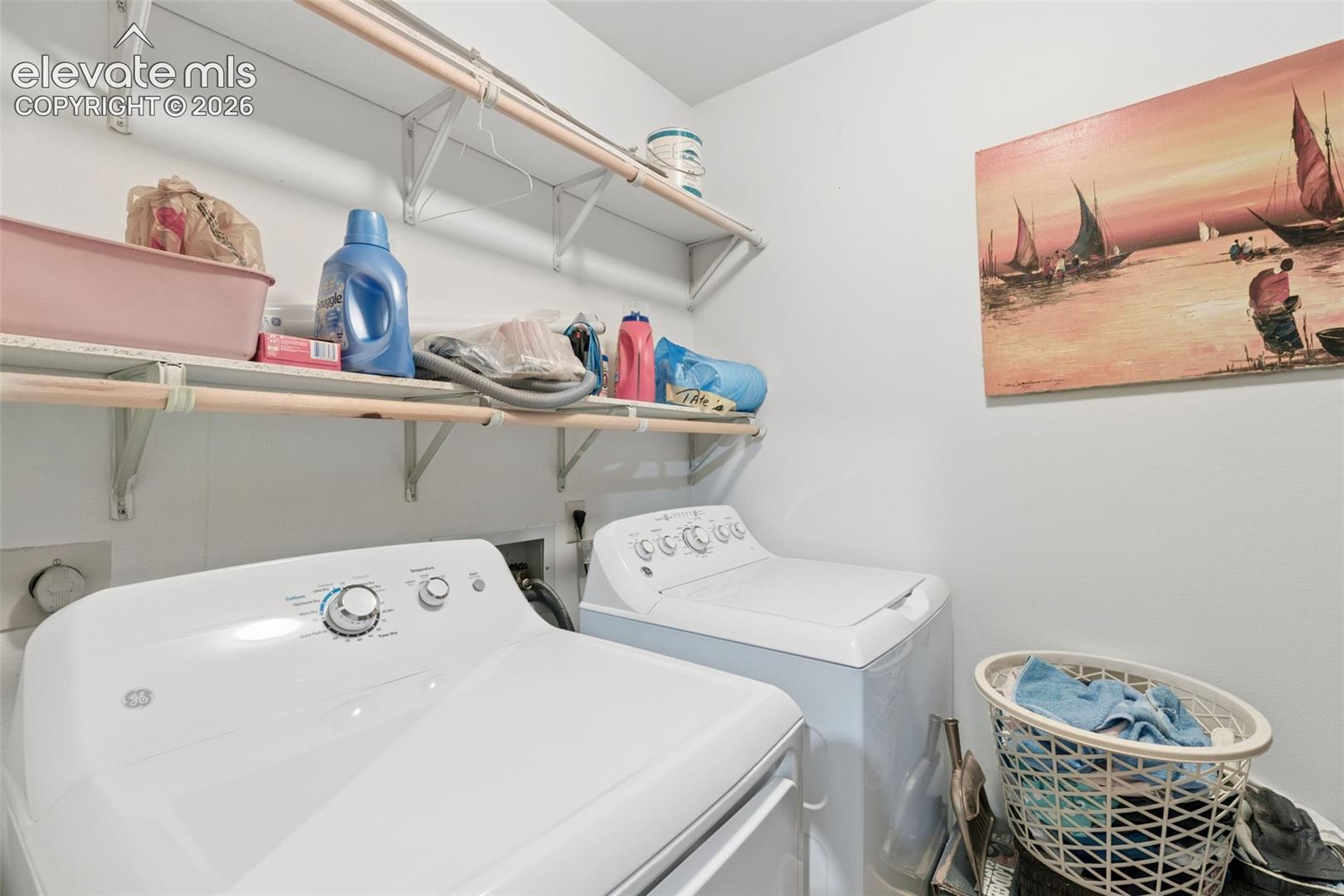 Utility space featuring two tiered levels of wall-mounted open shelving