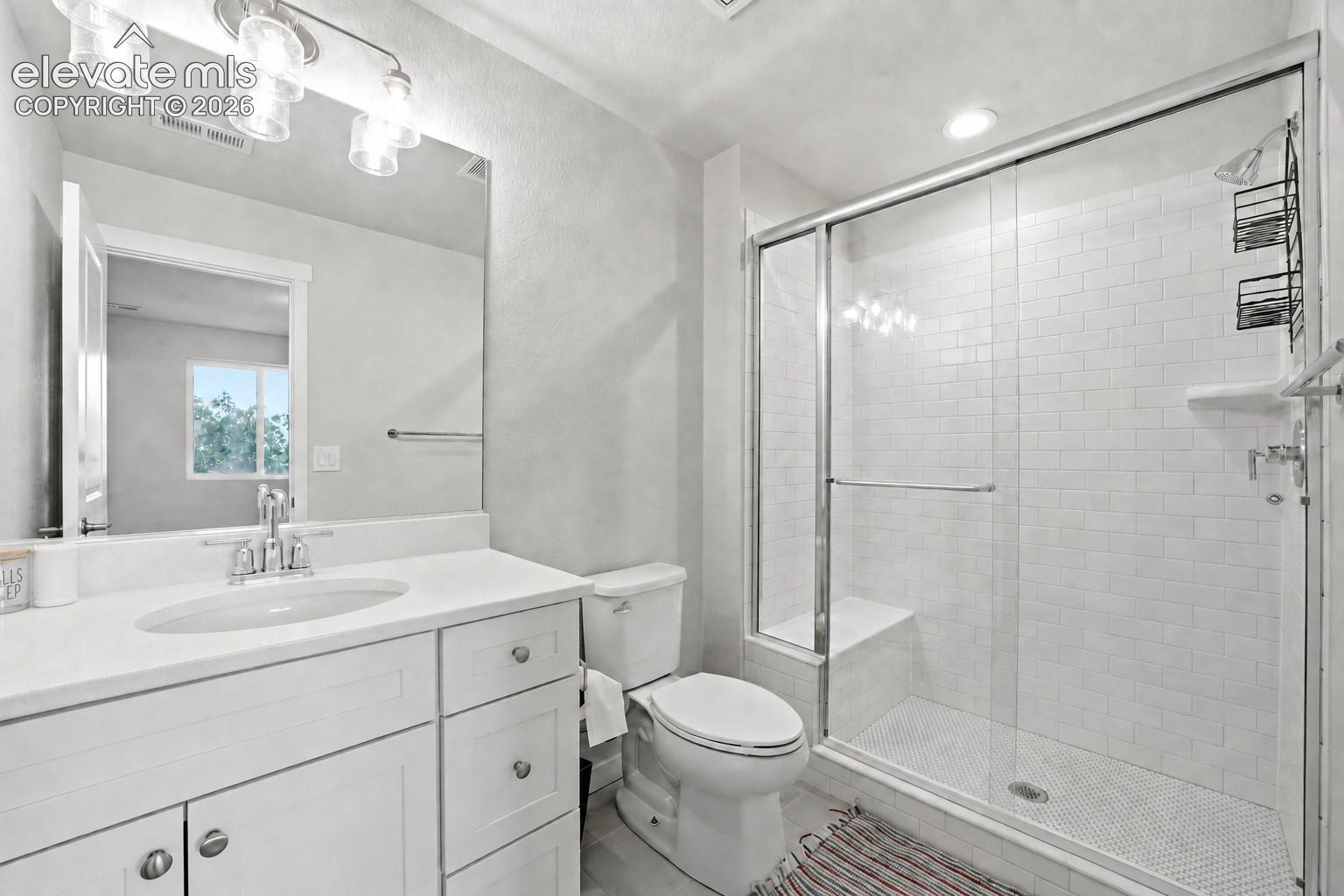 Bathroom 3 - White vanity with a single basin sink, white countertop, and chrome faucet