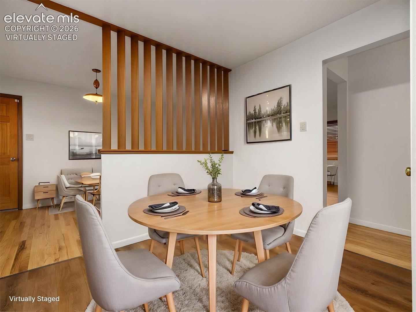 Virtually staged, Wood-finish flooring throughout, light wood room divider, and bright white walls