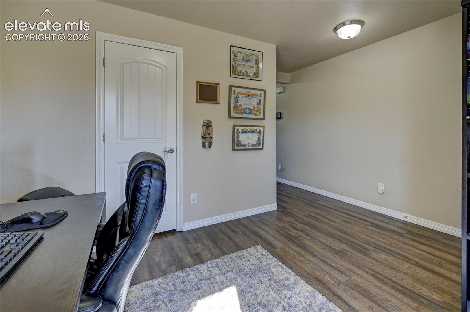 Wood-finish flooring with neutral wall tones and white trim