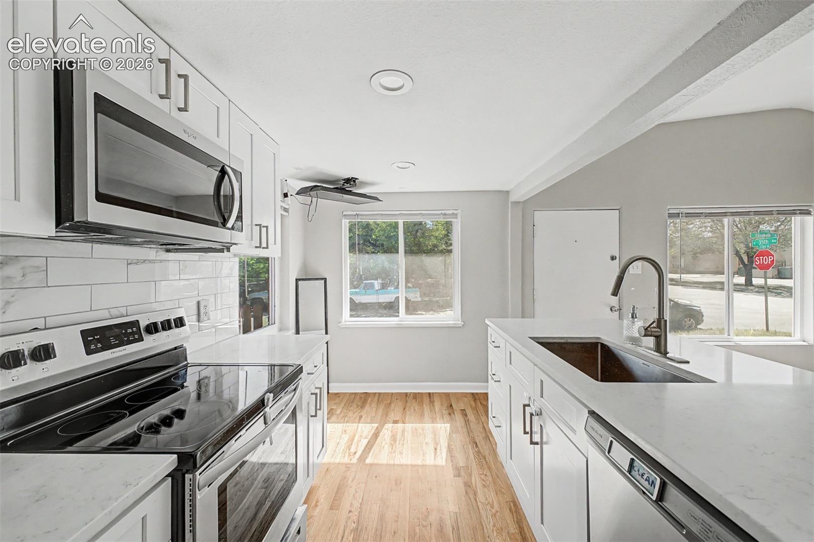 Recessed window, wood-finish flooring, and a crystal chandelier