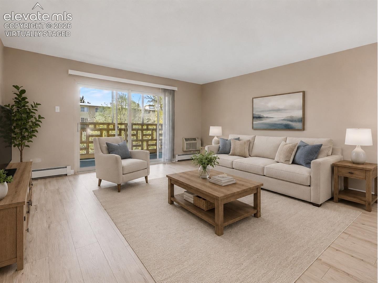 virtually staged Living area featuring light wood-finish flooring, neutral wall tones, and a sliding glass door opening to an outdoor space with decorative railing