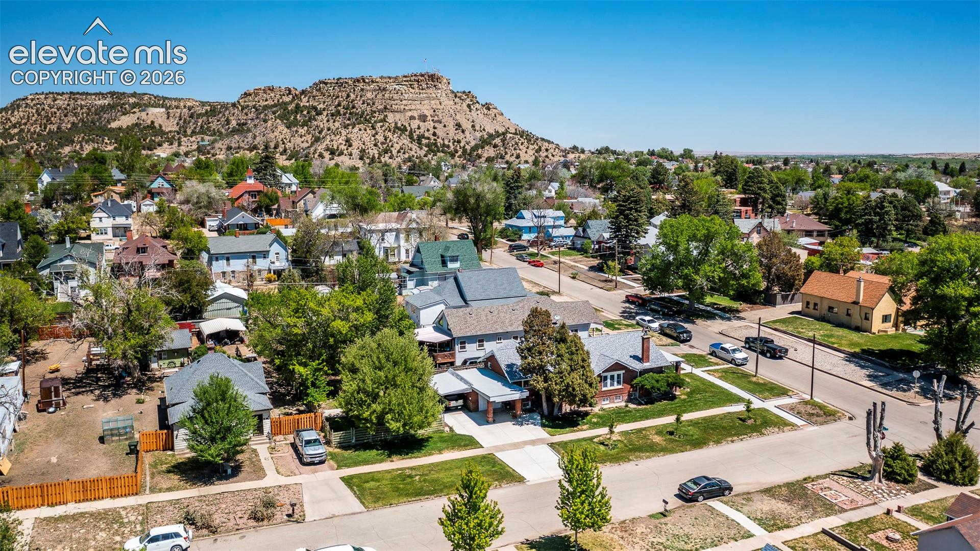 Neighborhood setting featuring mature trees, paved streets, and residential architecture