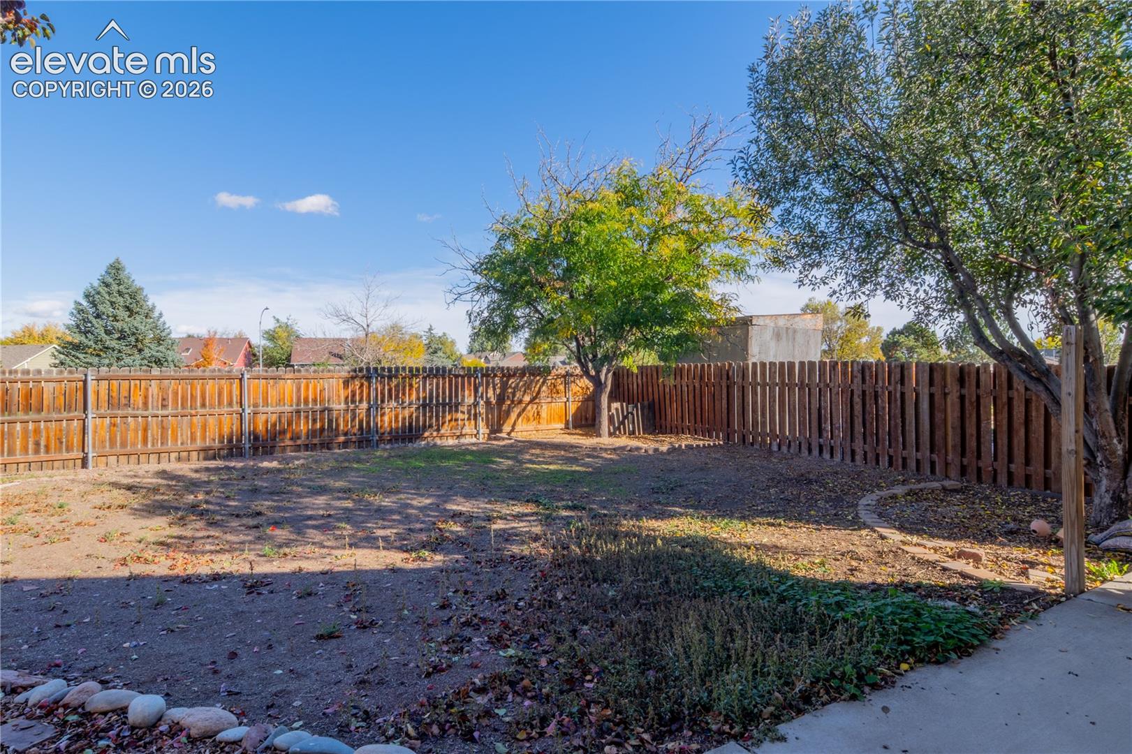 Plenty of outdoor space to enjoy, with wood privacy fencing and mature shade trees.