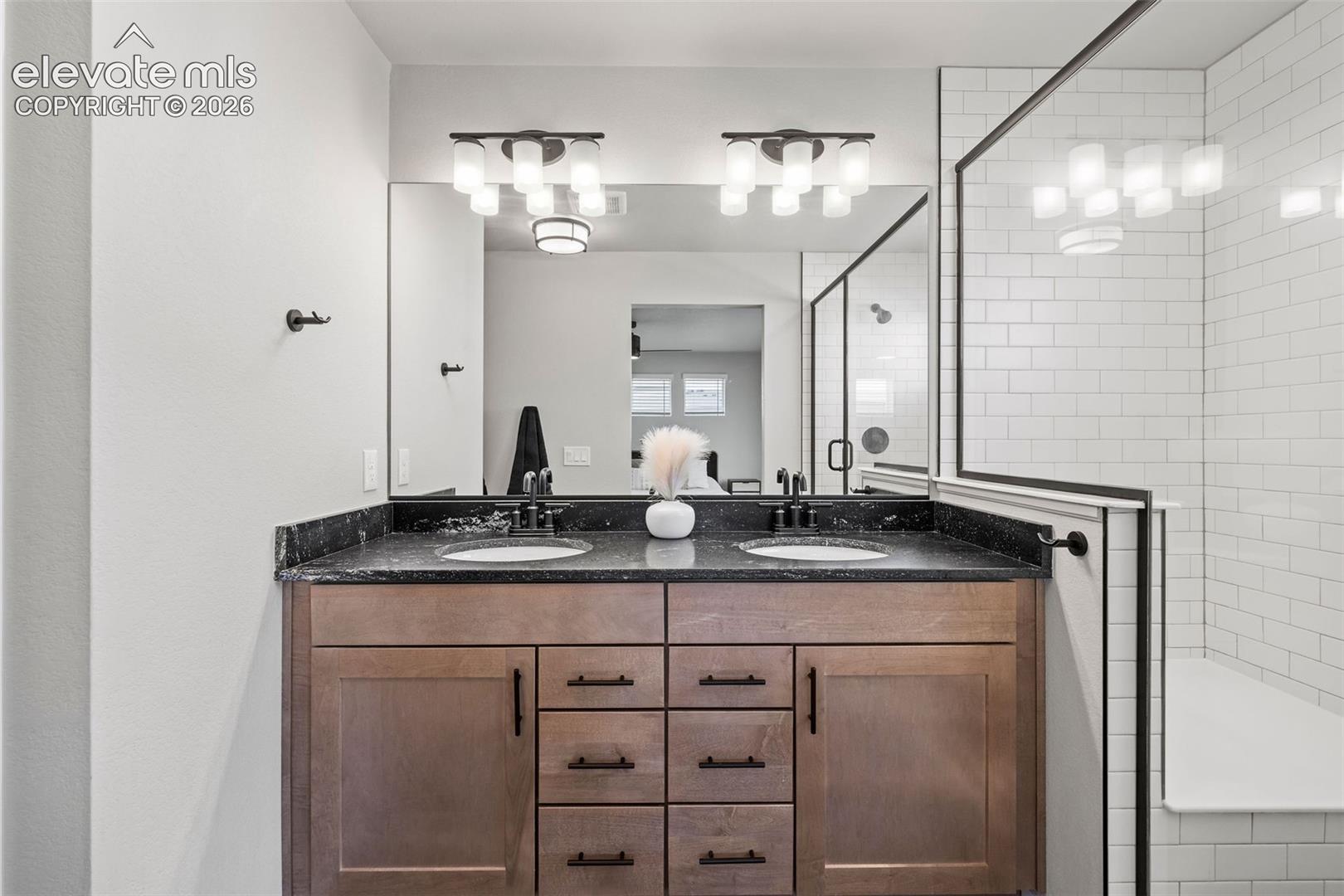 Happy relationships start with dual sinks. This vanity has lots of storage and a beautiful granite countertop.