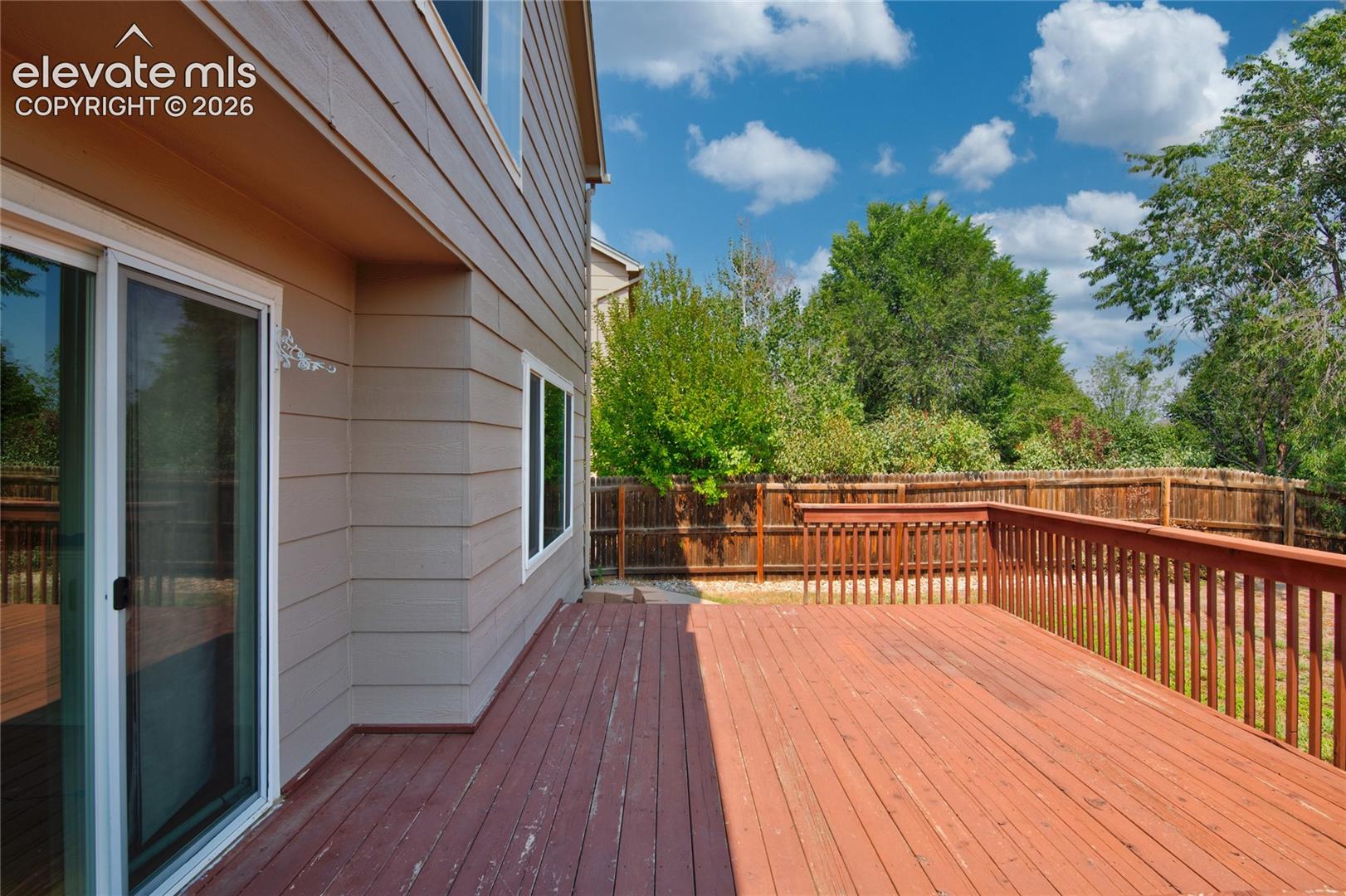 Expansive wood deck with a perimeter railing, offering outdoor living space