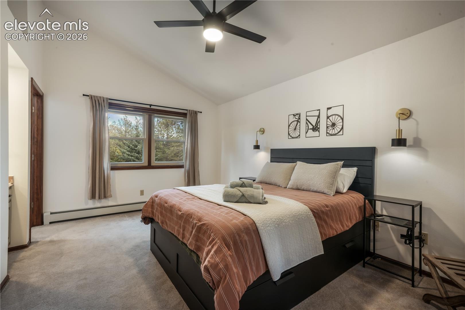 Upper level bedroom with vaulted ceiling