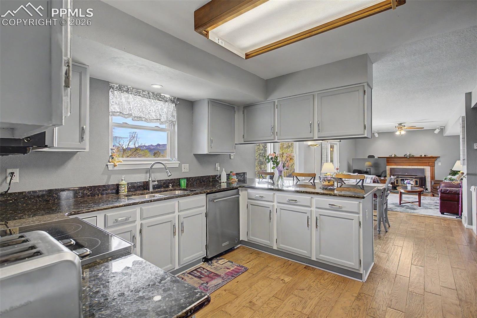 Coming from the formal dining room, enter the kitchen, breakfast nook, and living room.