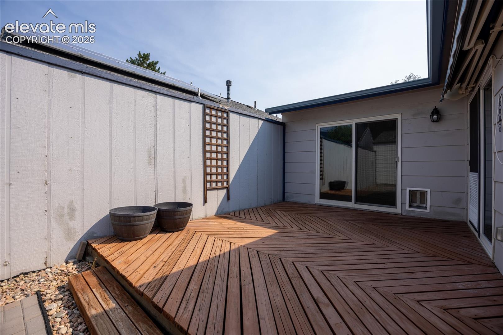 Wood-finish deck with a chevron pattern and steps