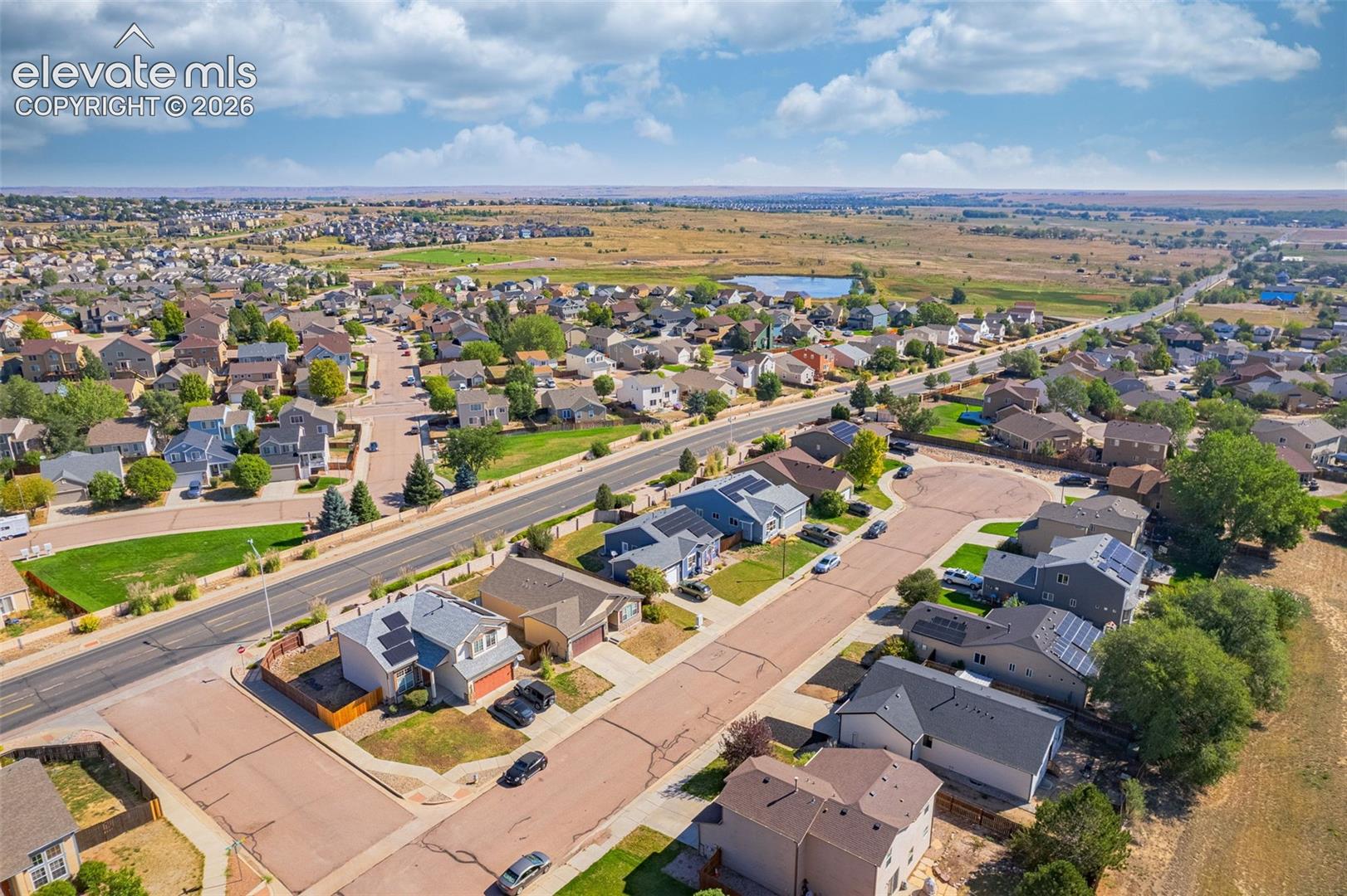 Residential neighborhood with diverse home styles, paved roads, and organized street layouts