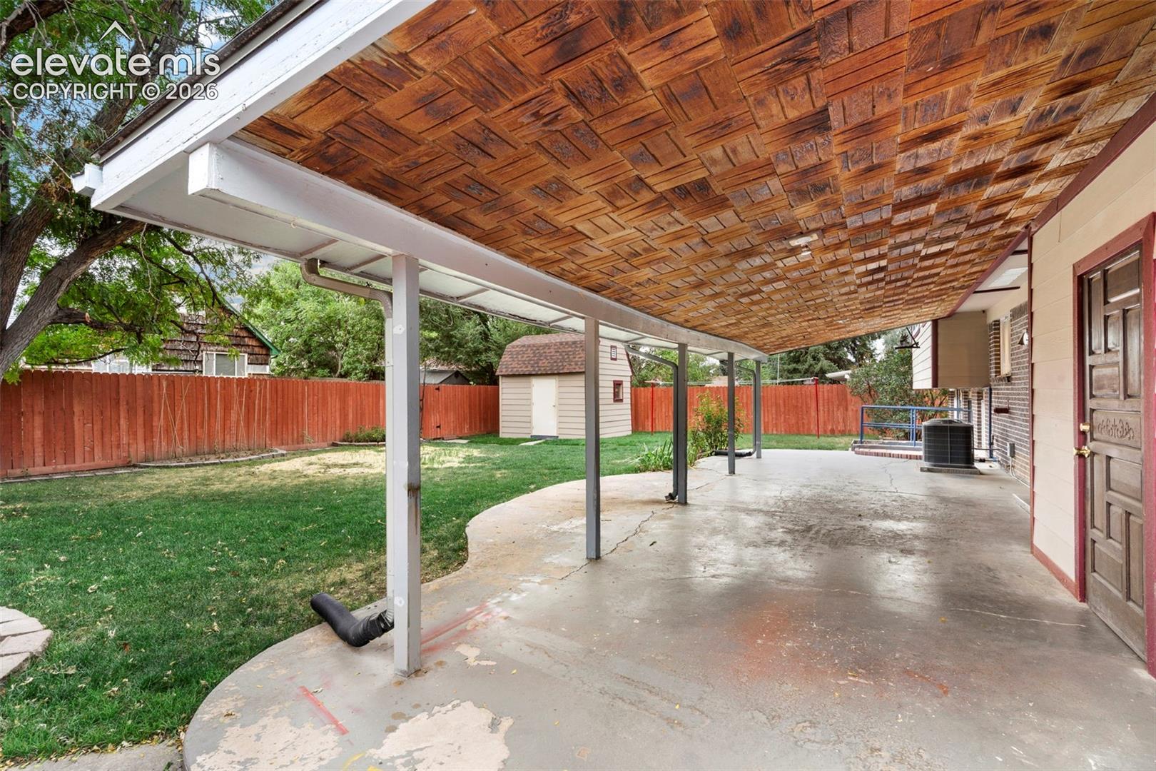 Covered patio with a textured wood ceiling, offering expansive outdoor living space