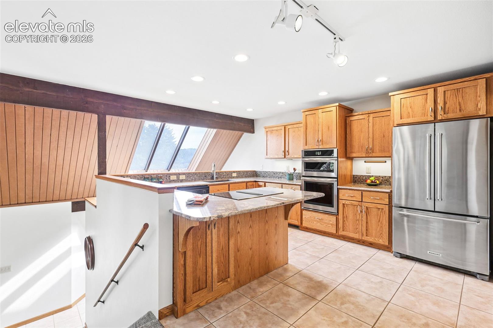 This well-planned kitchen features recessed lighting, under-the-counter lighting, built-in microwave/convection oven, full sized oven, and cooktop.