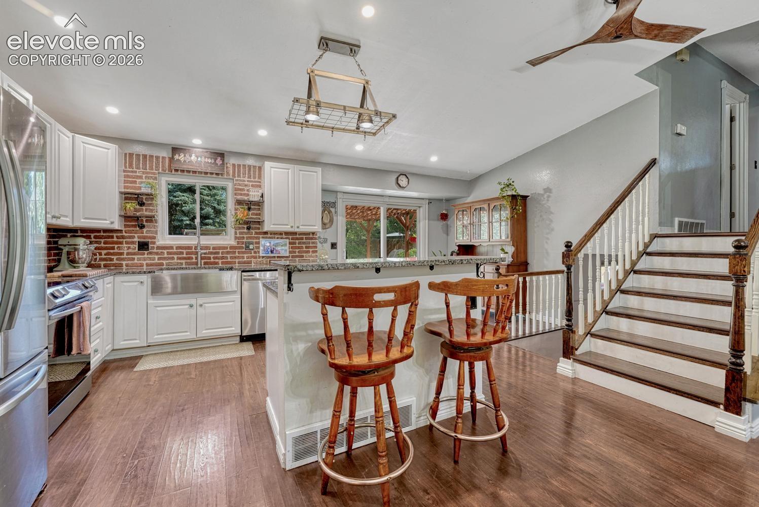 View of Kitchen and stairs to the upper level.
