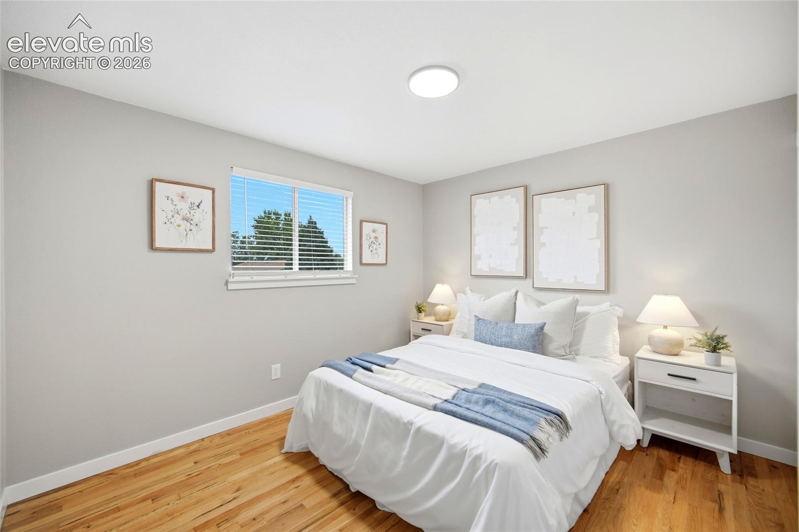 Recessed lighting, wood-finish flooring, and light gray wall paint