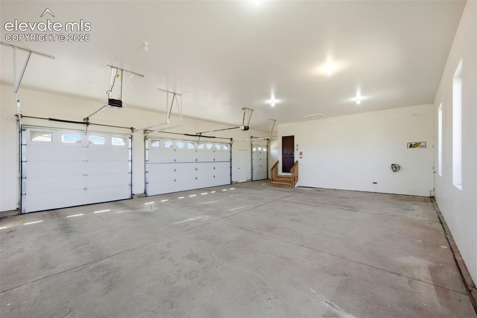 Attached 3 car garage PLUS golf cart parking