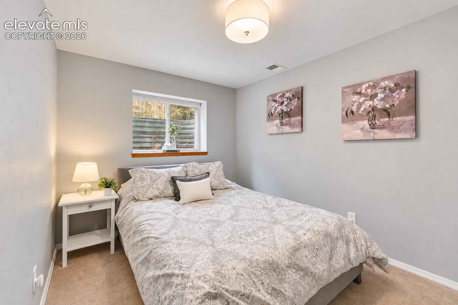 Basement Bedroom #5 has neutral carpet and crawlspace access for storage, and a walk in closet.