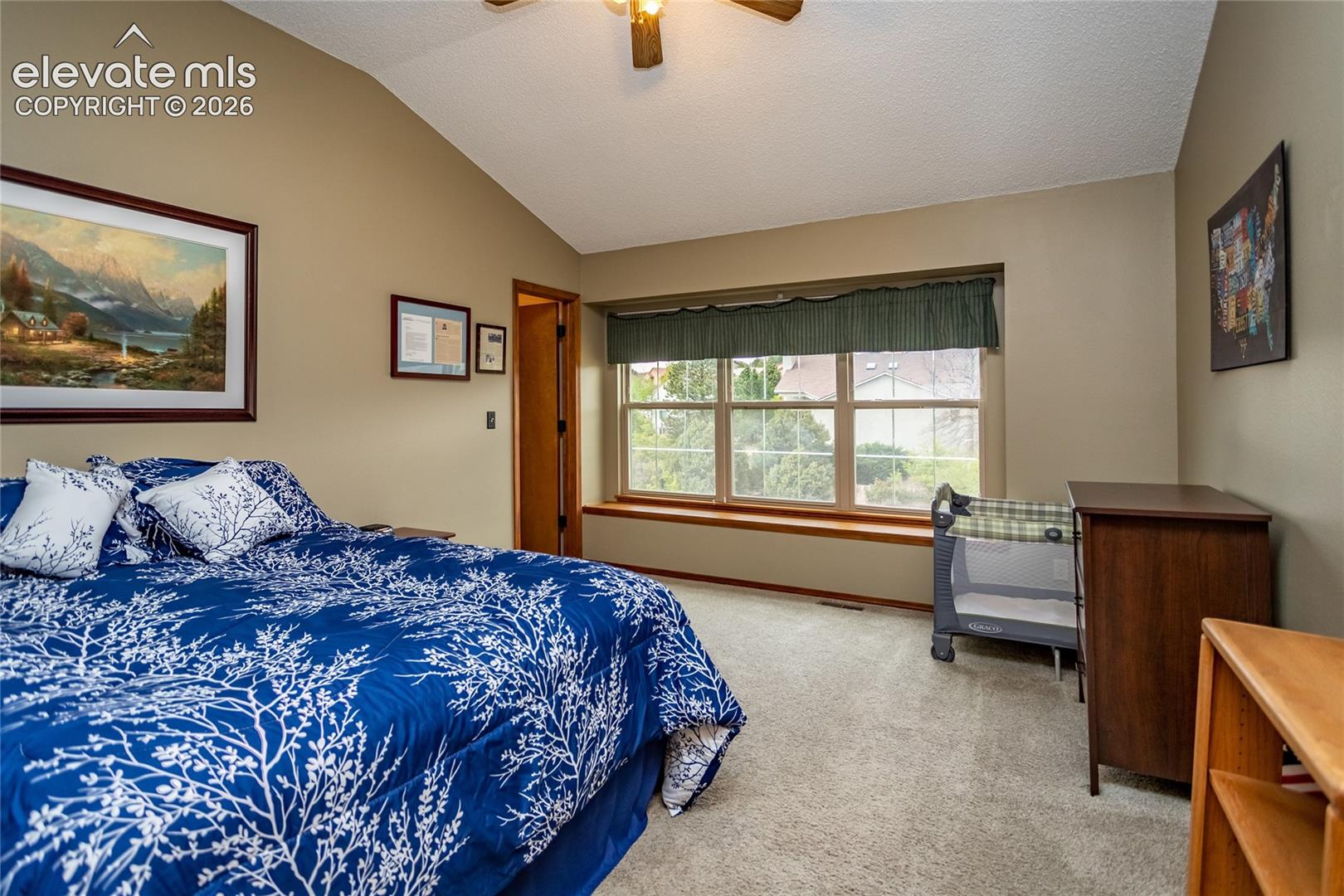 Fourth Bedroom on Upper Level (North facing) has Vaulted Ceiling and Large Windows