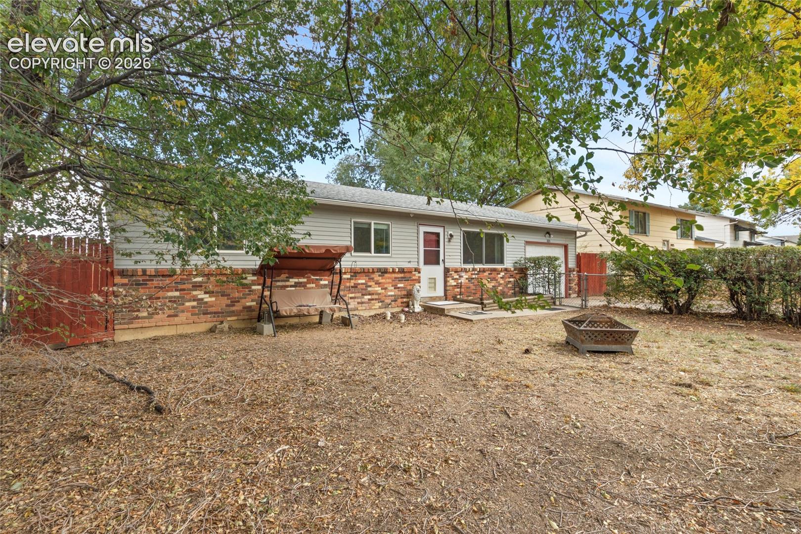 Fully fenced in front yard with hedges for privacy