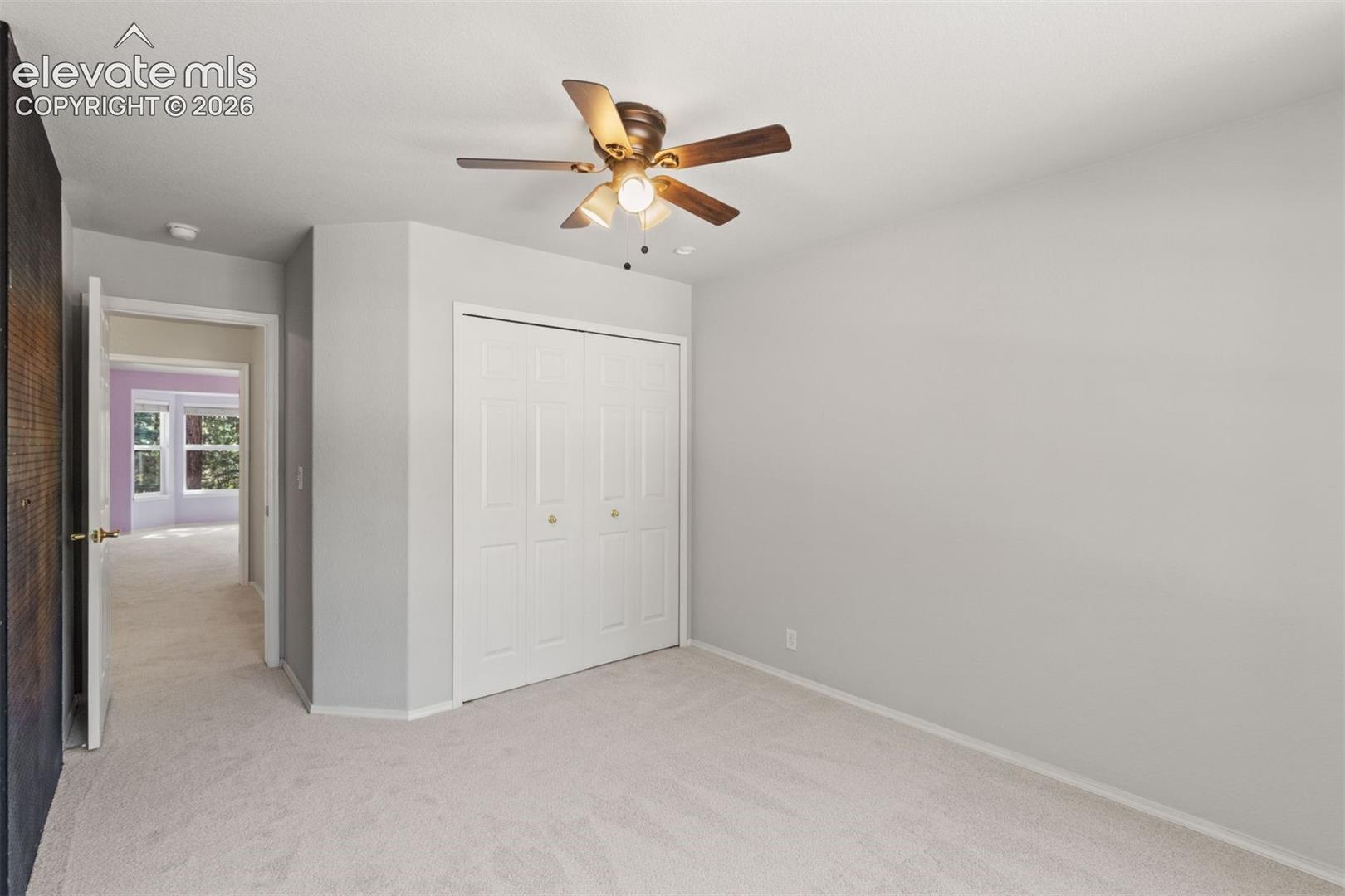 Upstairs bedroom with ceiling fan