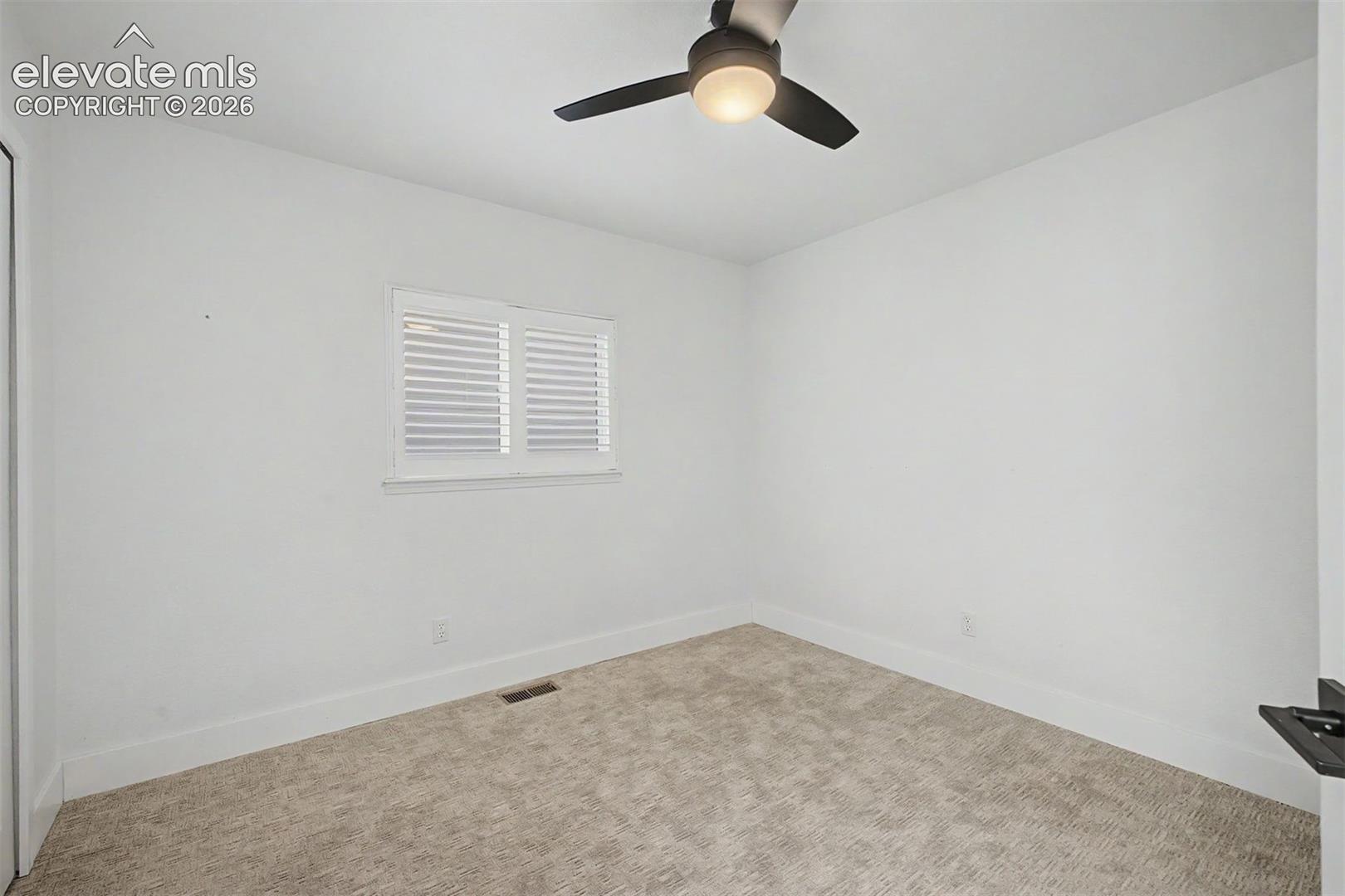 Main level bedroom with ceiling fan