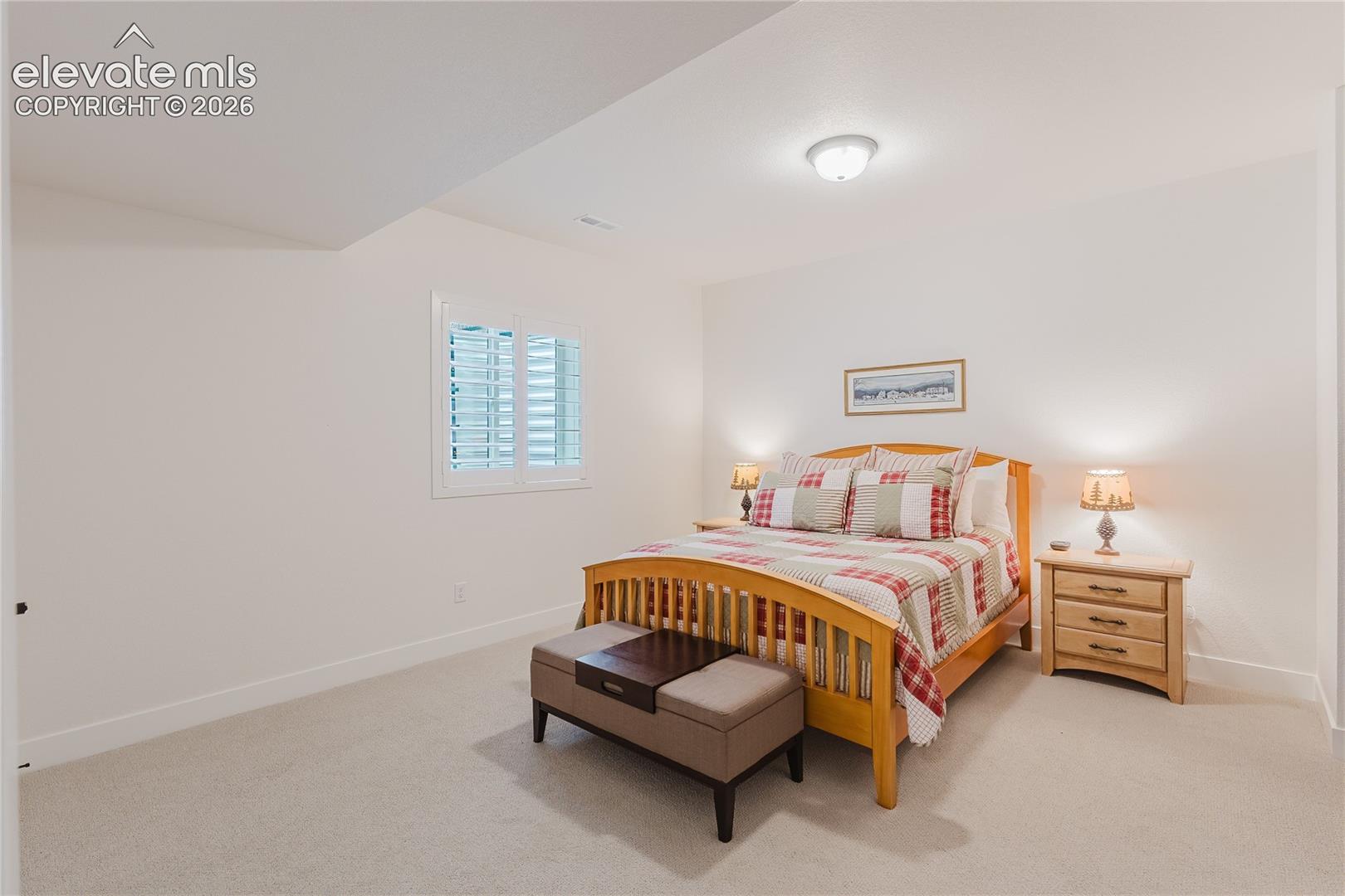 Bedroom in the lower level with plantation shutters and a walk in closet