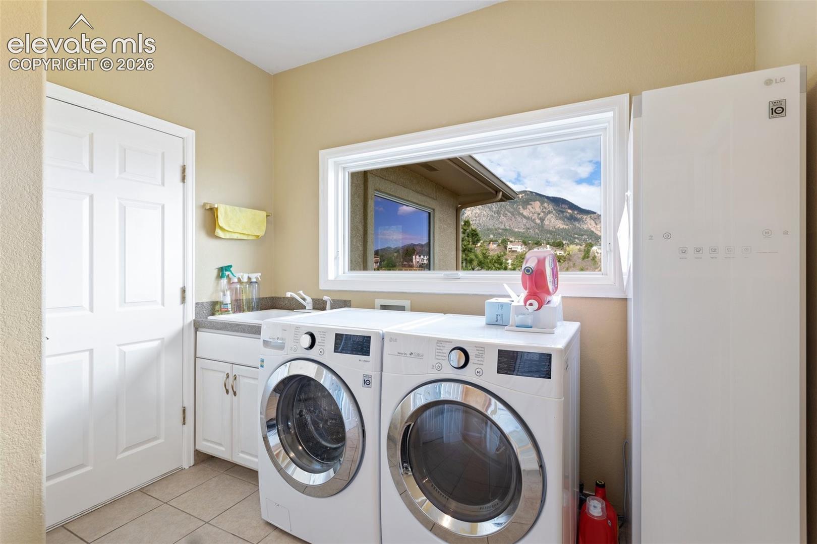 Laundry area with a mountain backdrop visible through the window