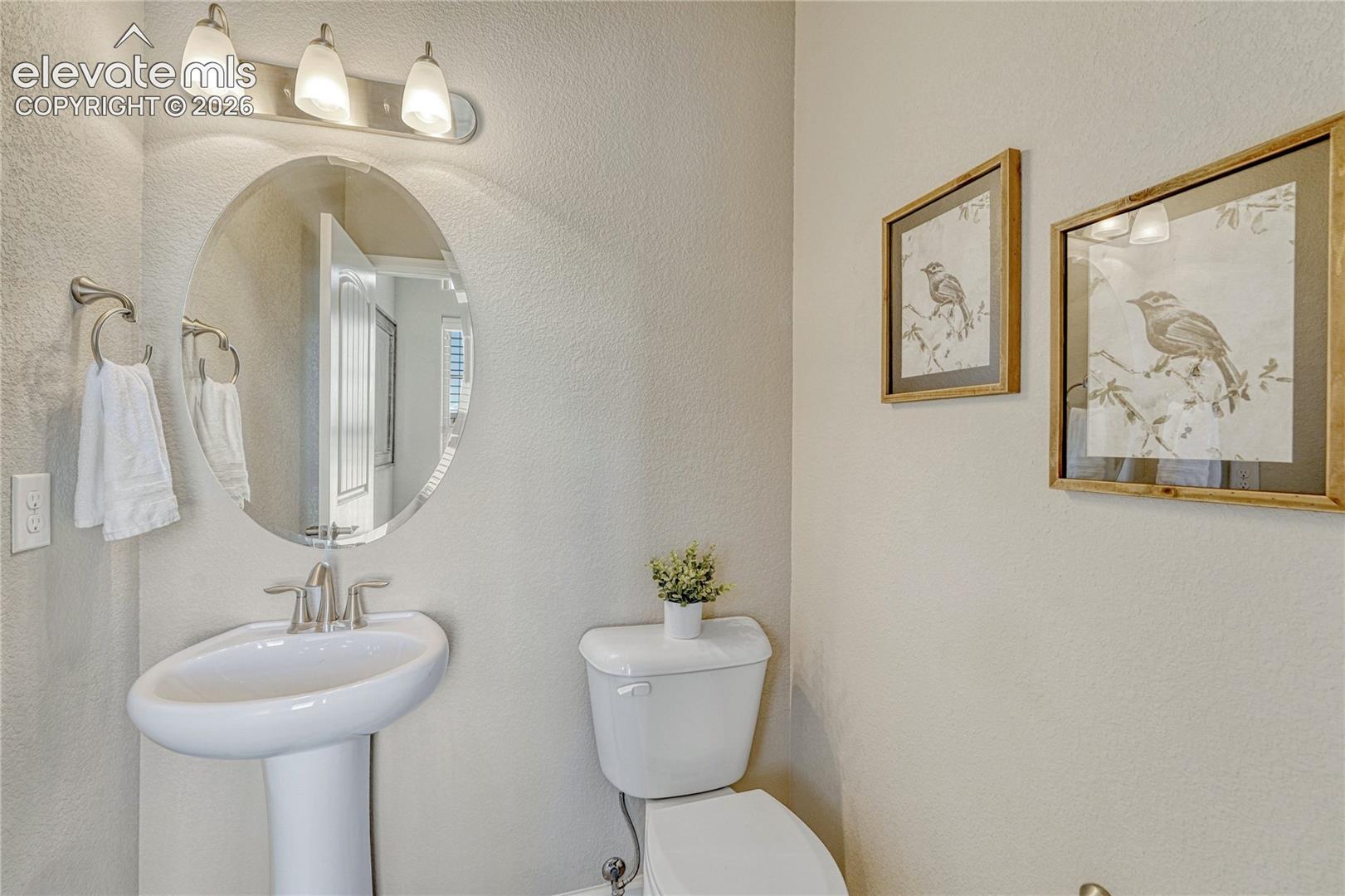A conveniently located half bathroom near the entry provides functionality for residents and guests alike.