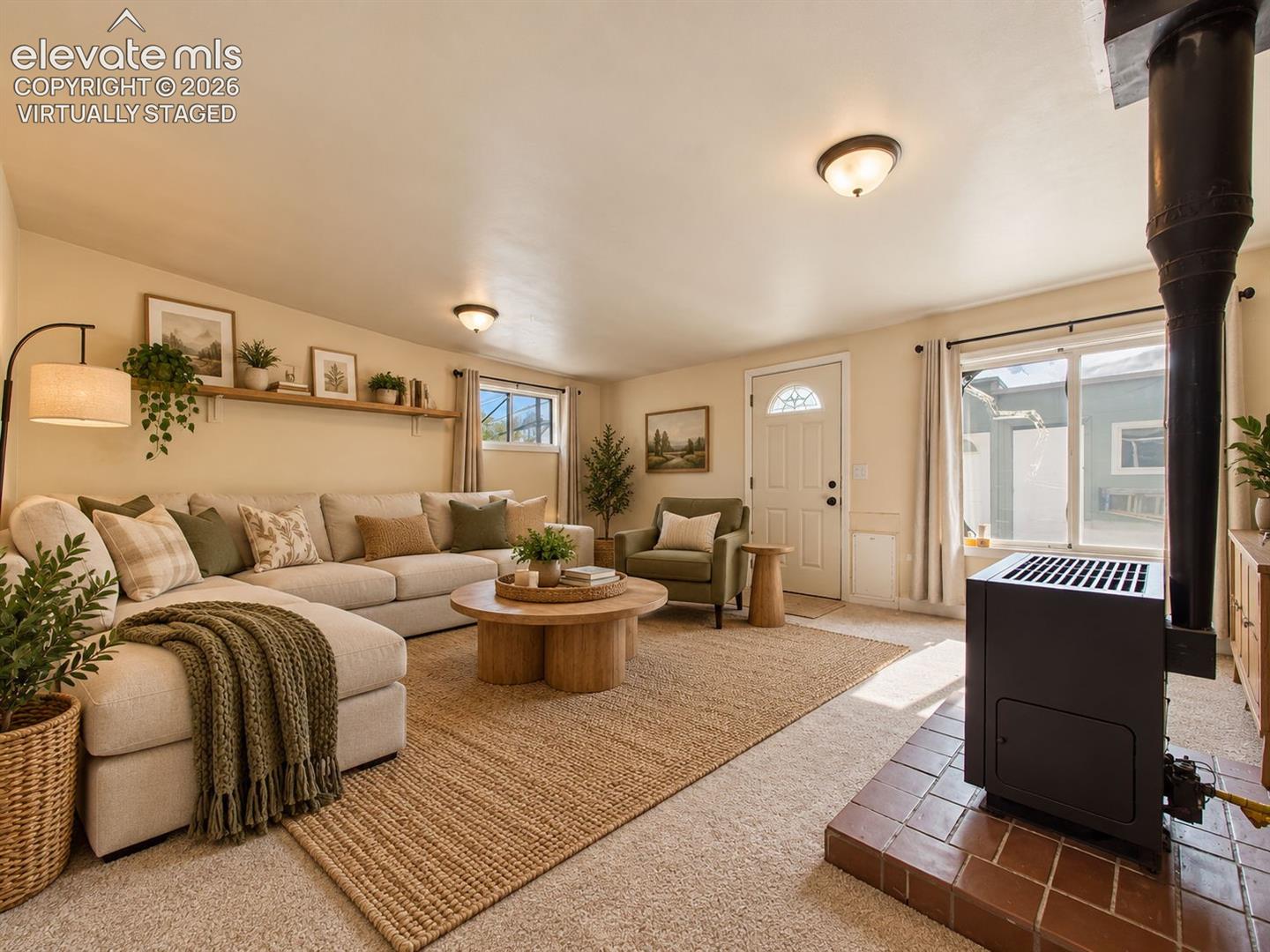 (Virtually Staged)
Spacious, inviting family room featuring a freestanding gas heater, abundant natural light, and comfortable space for gathering and entertaining.