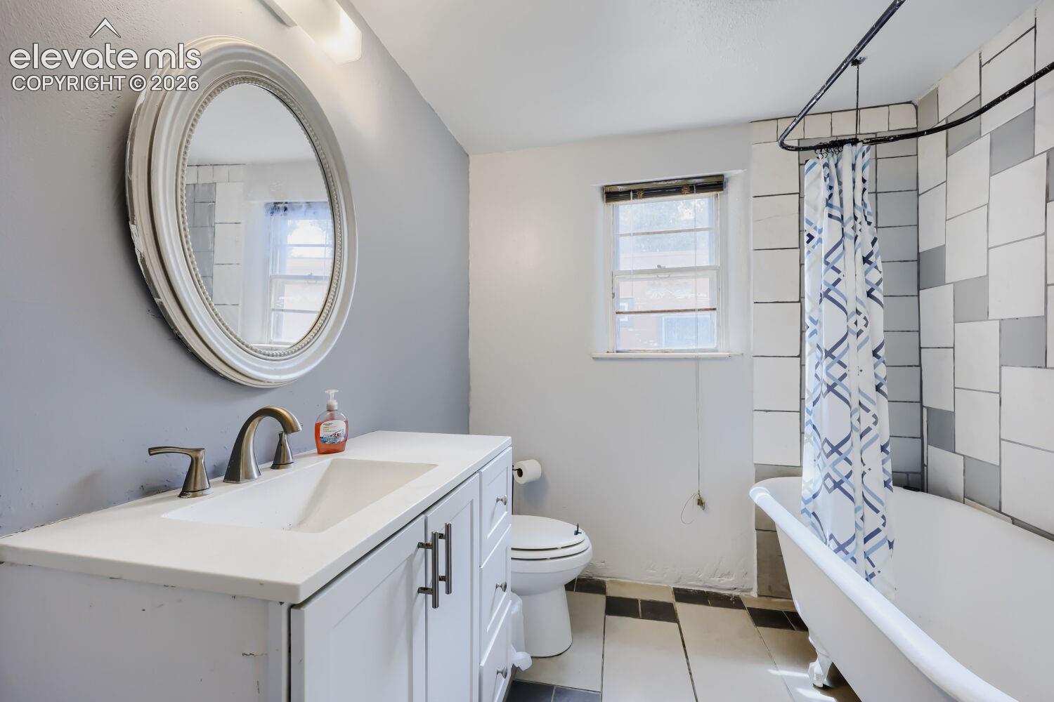 White vanity with an integrated sink and brushed nickel fixtures