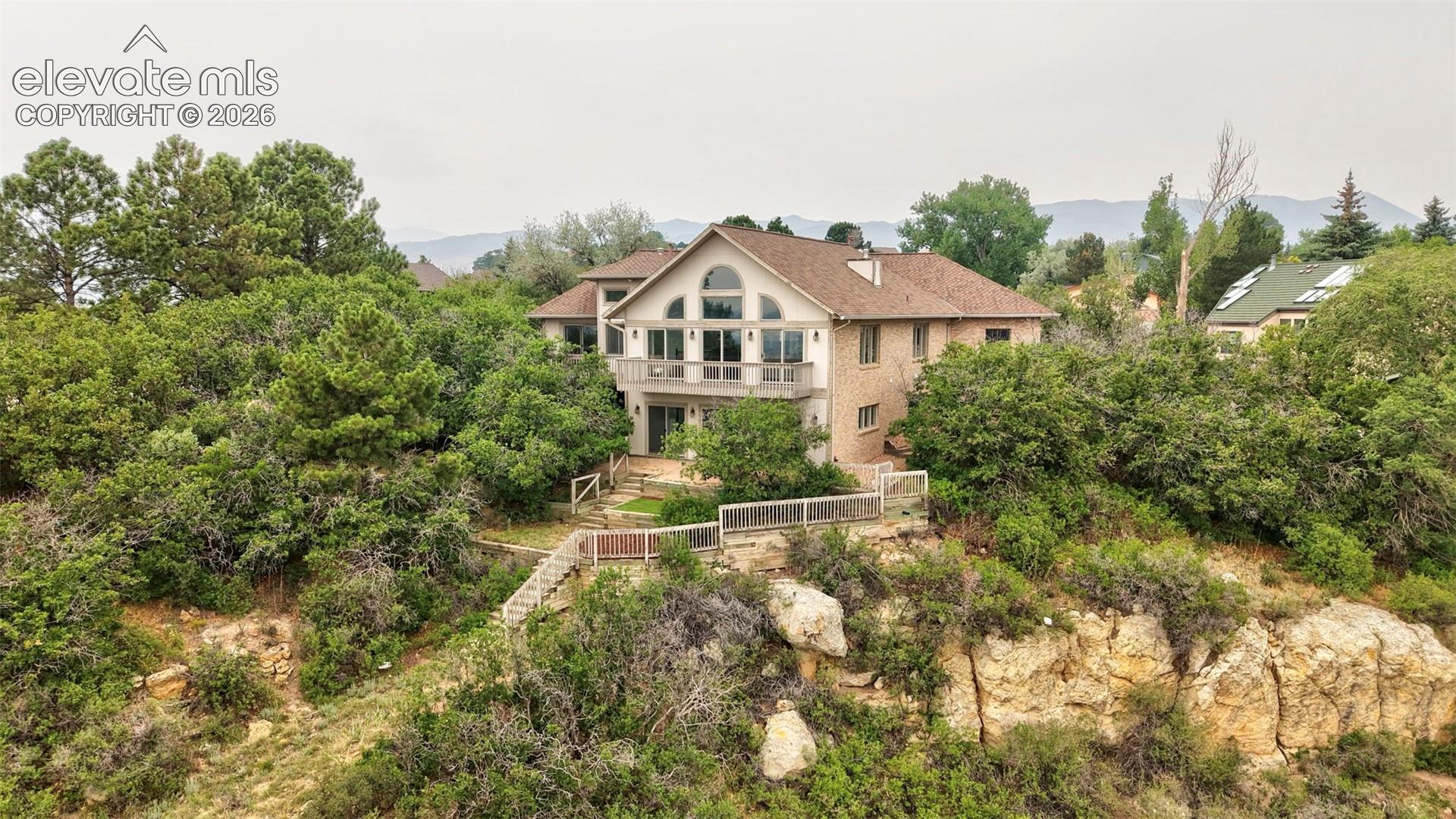 Hillside residence featuring a brick and stucco exterior