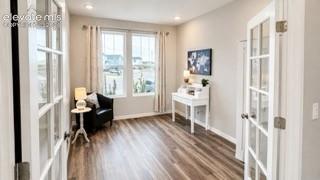 Primary level bedroom or office space. Tall ceilings, recessed lighting, LVP floors, French doors & next to half bath.