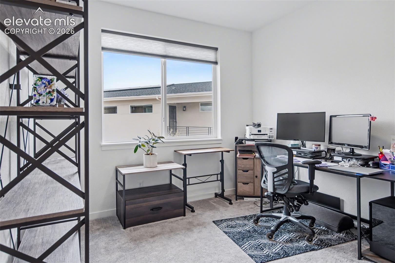 Office featuring light colored carpet and baseboards
