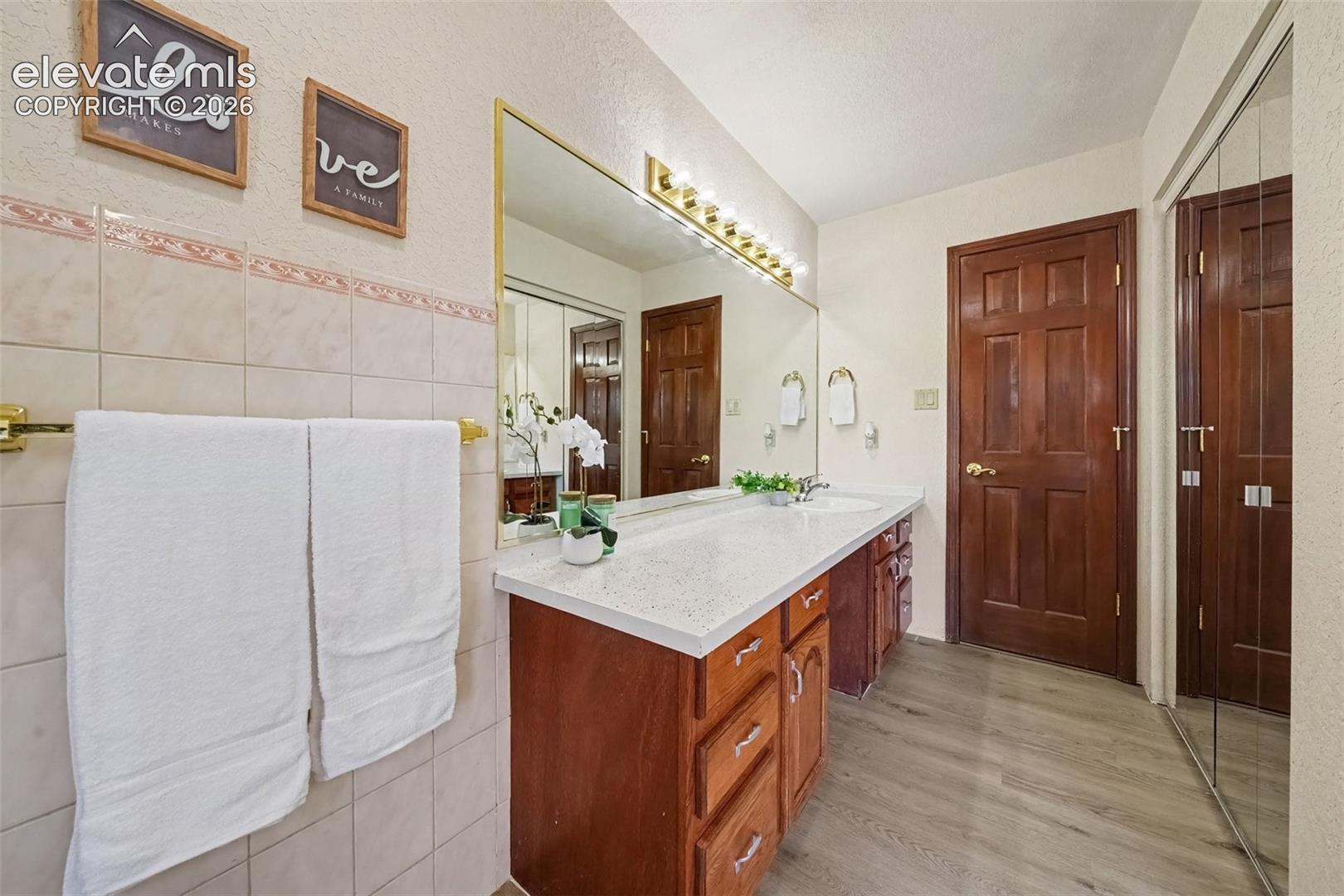 Spacious main-level bathroom featuring a generous closet and a tub