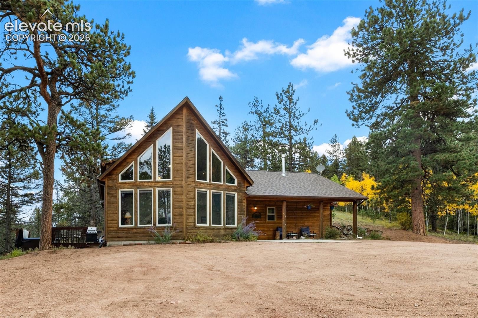 Log cabin style exterior with a prominent A-frame window design
