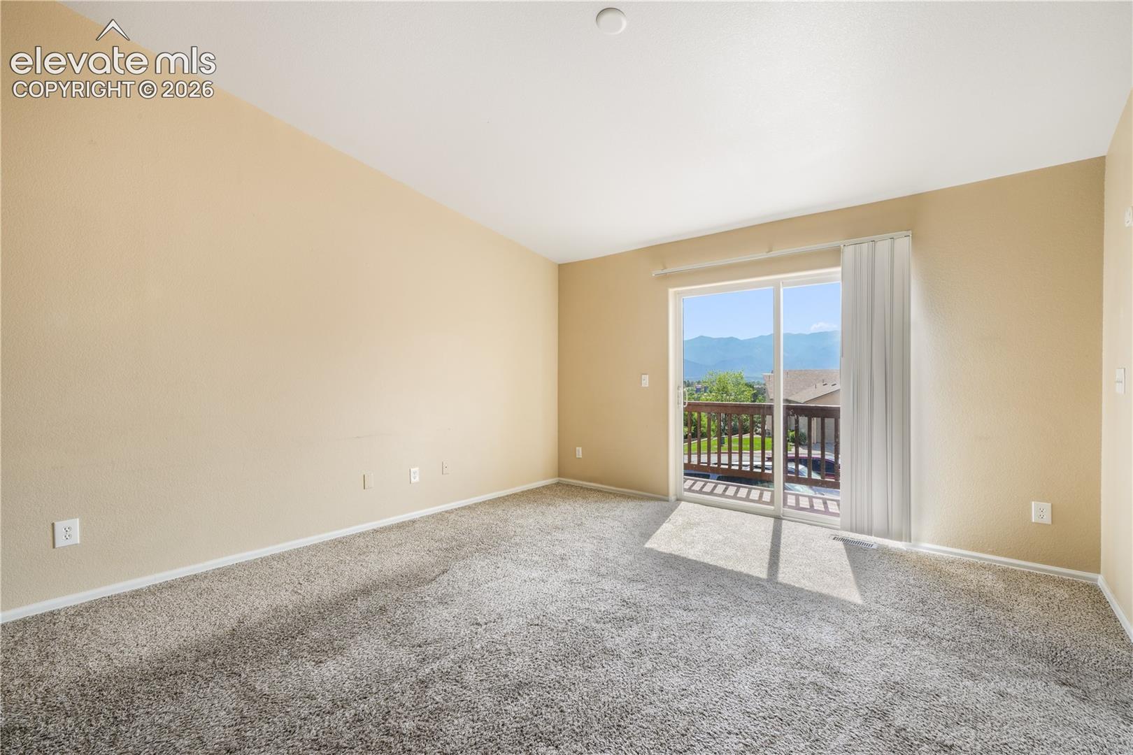 Living room with balcony access and mountain views