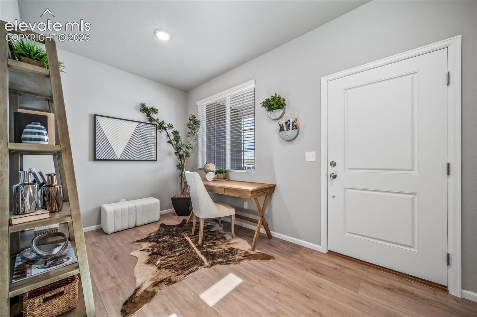 Wood-finish flooring, recessed lighting, white interior door with paneling, and natural light from a window with blinds
*photos of a model home*