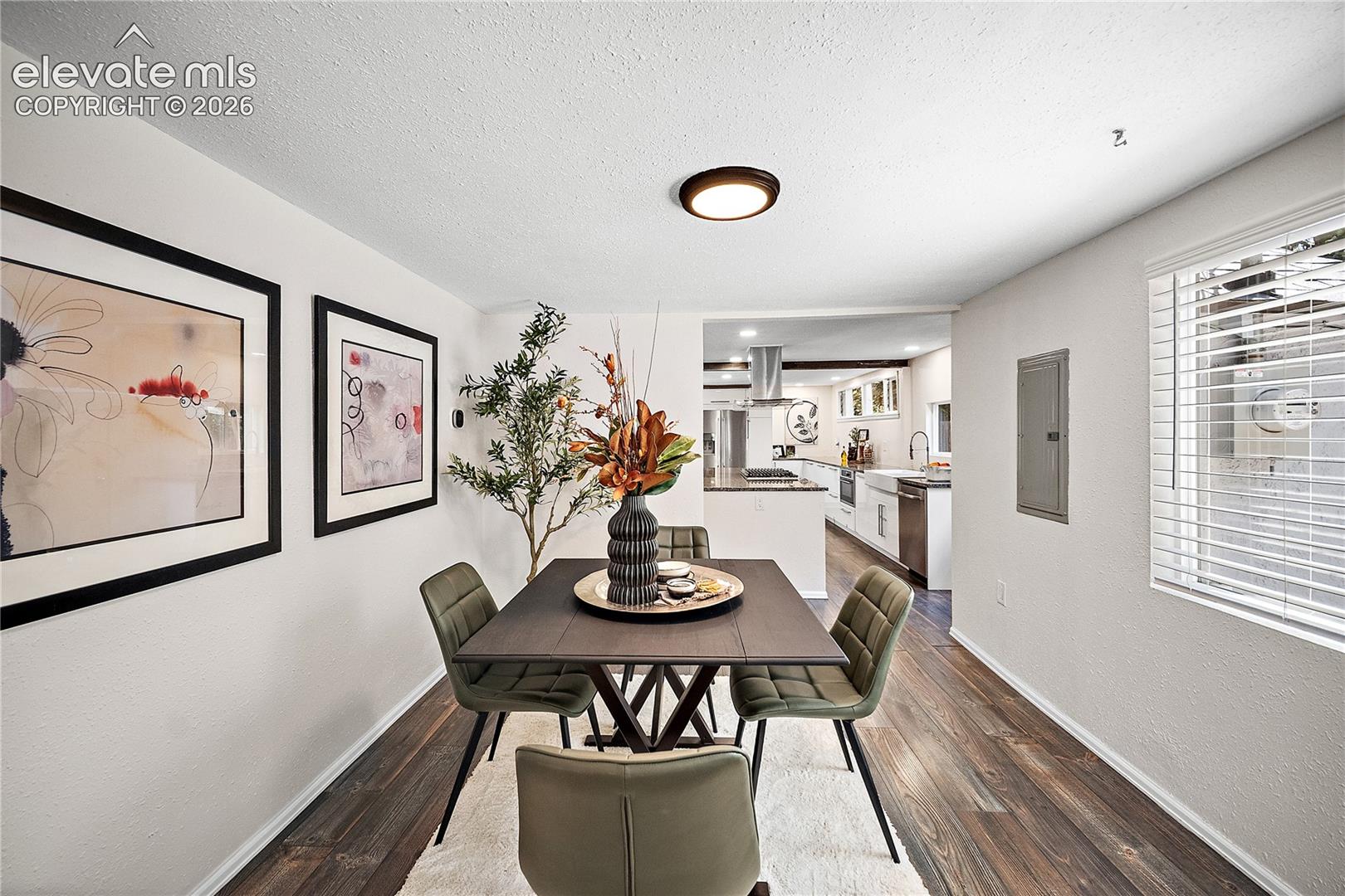 Dining area featuring wood-finish flooring and a contemporary flush-mount ceiling light