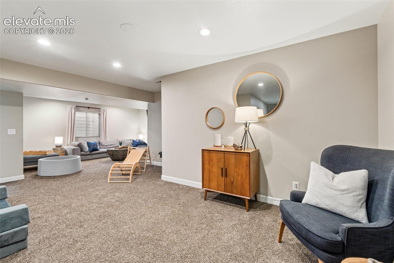 Neutral-toned interior featuring recessed lighting and wall-to-wall carpeting