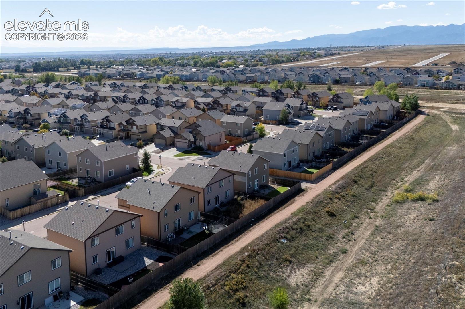 Residential neighborhood featuring multiple detached homes with pitched roofs, some properties include solar panels