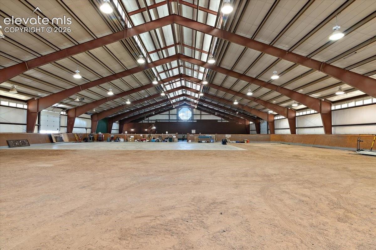 Dirt area is approximately 9,050 Sq. ft. Peak of the building is approximately 30 feet and sidewalls 14 ft. The concrete parking pad is 70 ft. x 56 ft., Tennis Court area is about 109 ft. x 60 ft., 2,525 sq. ft are living quarters