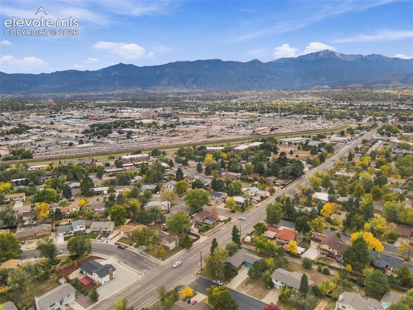 Aerial perspective featuring mountainous horizon and expansive suburban landscape
