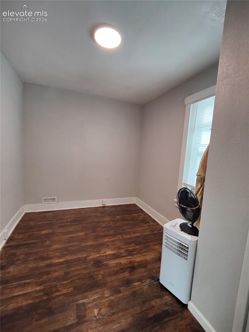 Recessed ceiling lighting, wood-finish flooring, white trim, and window with blinds