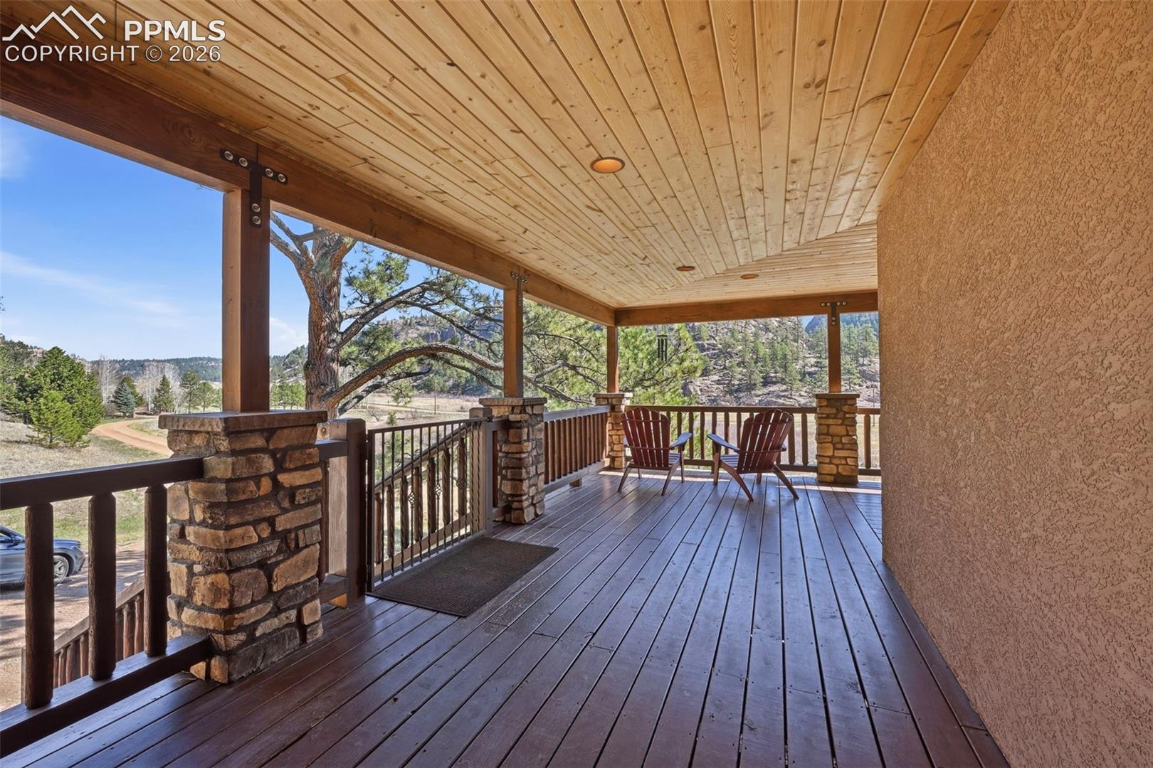Enter the property through a captivating wrap-around covered front porch. 