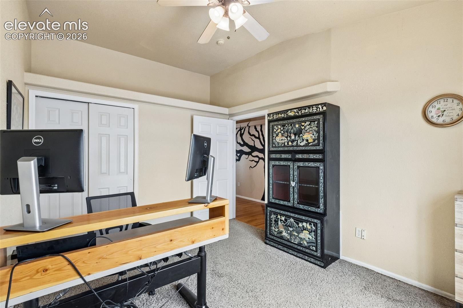 Vaulted ceiling, ceiling fan with light kit, and double-door closet