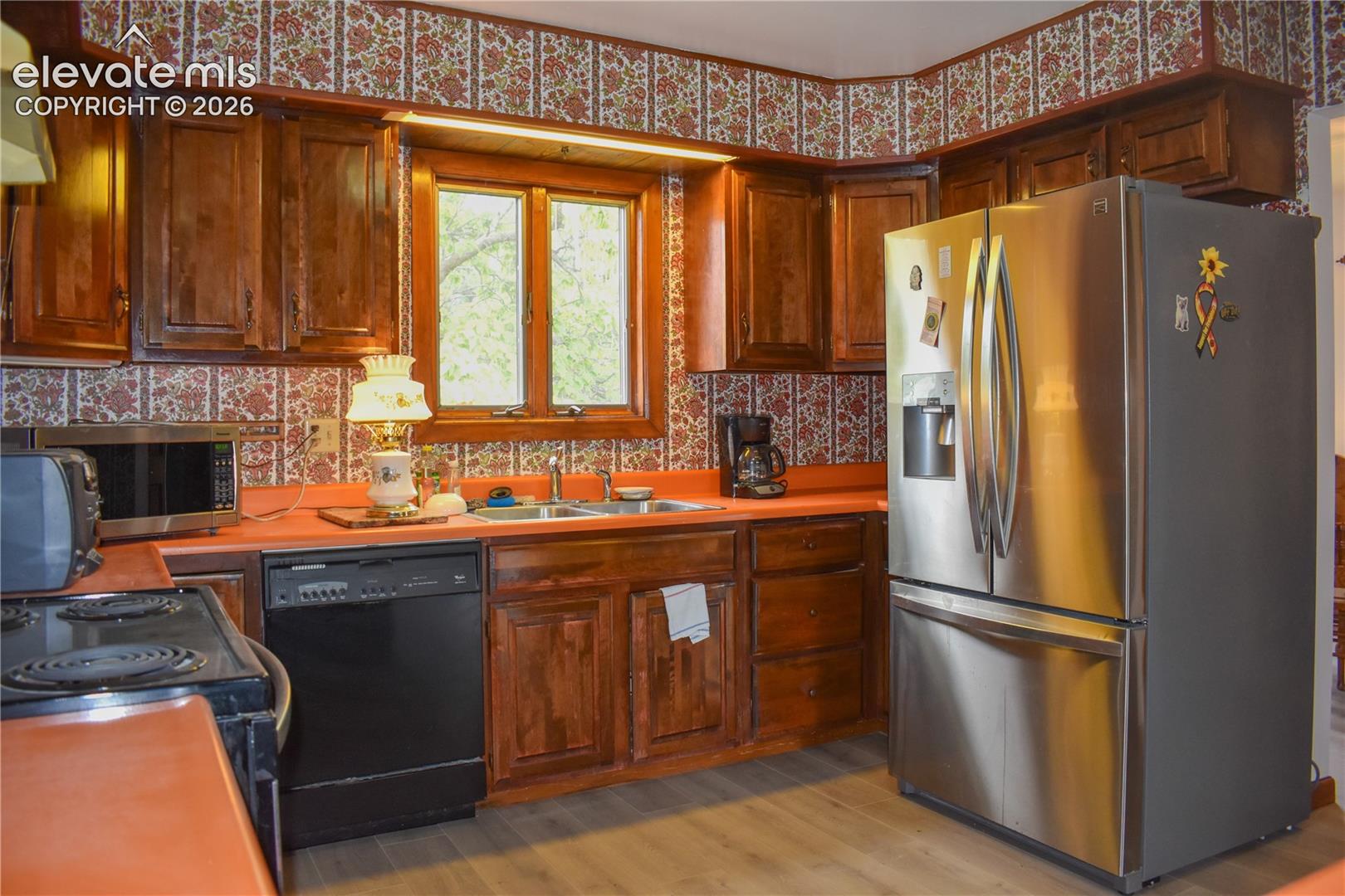 Wood-finish cabinetry paired with orange countertops